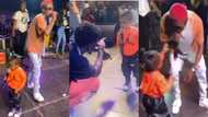 Strongman's 2-year-old daughter snatches mic from Kuami Eugene as she joins dad on stage to perform (Video)