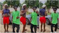 Ras Nene rocks crop top, tight shorts & brown shoes as he dances with Strongman