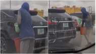 Mobile Car Wash: Innovative young man spotted in video washing moving cars on the road