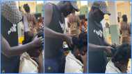 Ghanaian man shows care to wife, fixes ponytail hairstyle for her in public, video sparks reactions