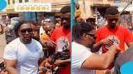 Ghanaian macho man doles out money to street boys in Kumasi: "God bless you, Godfather"