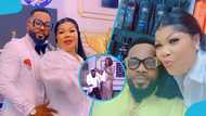 Agradaa’s husband Angel Asiamah kneels before her as she sprays cash on him in front of church members