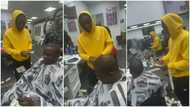 Young man brings out wads of dollars from his pockets, sprays it all on his favourite musician at barbering salon