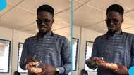 Ghanaian school pupil presents Club Beer as Our Day gift to class teacher who is a pastor