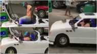 Man stirs reactions as he drives to filling station with a toy-like car to fill tank