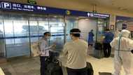 China halves quarantine time for overseas travellers