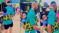 Reactions as man storms market with baby on his back, video goes viral": My husband should learn"