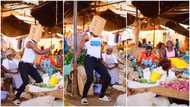 Man goes to market wearing singlet, puts carton over his head & starts shaking waist for old women in video