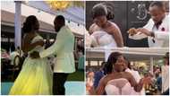 Ghanaian bride rocking a white deep-plunge white gown shows off her dance moves