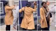 “She's crazy”: Angry lady seriously smashes ATM with her heels; fights with man in video; many react