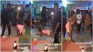 Lady in dress dances on her belly like snake at club, throws legs up in video, people stood up in awe