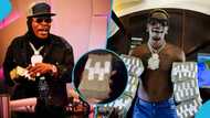 Shatta Wale pulls "Ghana Must Go" bag from his Lamborghini and gifts his associate stacks of cash