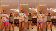 Mother & daughter whine their waists in video with great energy to song; gets men reacting