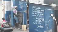 Street vulcanizer in Accra spotted teaching young boy serious English