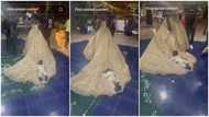 "This marriage is already blessed": Reactions as kid lies on bride's flowing dress while she dances