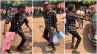 Young student dances in crazy way while carrying placards; whines his waist in video; many react