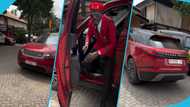 Lil Win flaunts brand new Range Rover Velar, rocks red suit to match