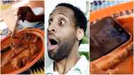 Why did he do that? Video of man dipping iPhone into fufu and soup with assorted meat and fish causes stir