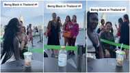 Gorgeous Black lady turns tourist attraction as 'obronis' take photo with her in Thailand