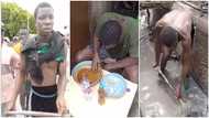 Nigerian boy caught stealing in Accra made to clean gutter, clothed & served banku afterwards in video