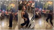 Barefooted beautiful lady in black sets bar on fire with crazy dance steps, ladies spray her money in video