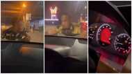 Stubborn man hangs on to bonnet of moving car after lady refused to give him cash, video goes viral