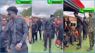 Kuami Eugene rocks longsleeves, trousers and boots to father's funeral; chews gum in video