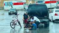 Kind Man Praised for Braving the Rain to Fix Young Boy's Broken Bicycle