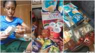 Nigerian lady prepares to go to school, loads box with milk, soft drink, corn flakes: "Bag like supermarket"