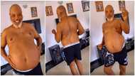 Shirtless man with pot belly dances to Kizz Daniel's Pour Me Water with great energy, whines waist in video