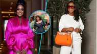 Ghanaian actress Jackie Appiah looks classy in a black corseted dress and designer bag