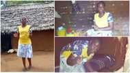 A woman proudly flaunts her mud house in the village