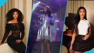 Singer Becca rocks sparkly silver dress while holding a matching Stanley cup to perform at an event