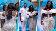 Tima Kumkum looks breathtaking in a white corseted gown designed with rhinestones for her son's christening