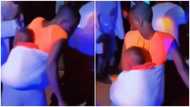 Eeeish - Lady carrying baby at her back causes stir with her unusual dance moves at party; peeps react