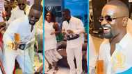 Sarkodie enjoys dance with Despite's children, holding wine glass steadily