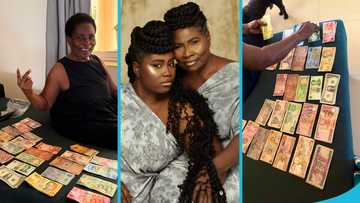 Lydia Forson's mother, Janet Forson, displays the notes she had collected from around the world