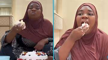 Lady's unusual eating habit causes uproar on social media: "She eats cake like It's banku"