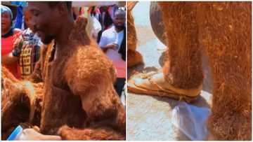 Ghanaian man showcases the clothes, slippers and bag he made from wood
