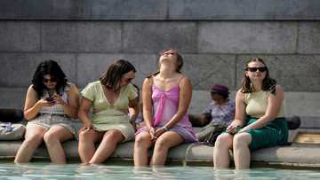 Britons desperate to cool off as mercury hits historic 40C
