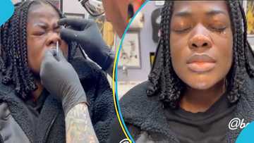 Asantewaa cries and screams as she re-pierces her nostrils in New Jersey in the US