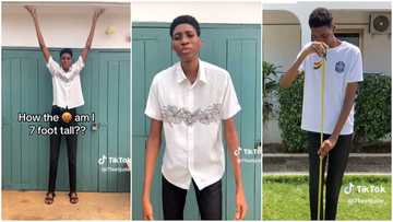 7 feet tall man shows off his height, mother is 5 feet 8 inches, people advise him