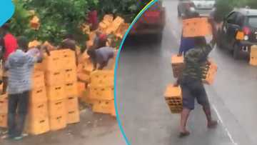Residents rush for spilt Guinness beverages on the Accra-Kumasi Highway after a truck mishap