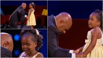Little girl holds hands with popular TV host who kneels before her and prays for him
