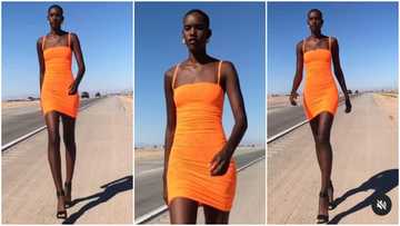 Very tall lady flaunts her fine and long legs as she models on pathway in video; many react