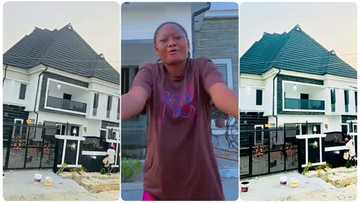 Lady builds her own house within seven months, stands beside it and dances happily