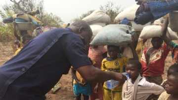 Beautiful photo pops up of police chief offering water to children displaced in Chereponi conflict