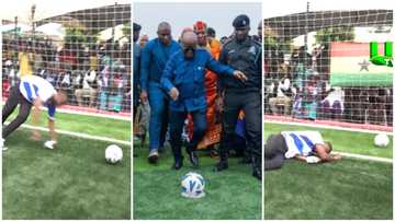 Nana Addo kicks a football as he commissioned the Alajo astroturf facility and got people applauding him