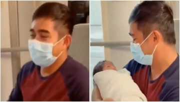 Emotional moment father carries his baby for the first time captured on camera, cute video warms hearts online