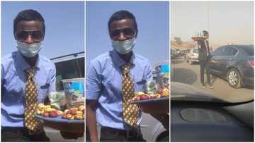 Young man in suit and tie hawk nuts, sweets in traffic; video goes viral